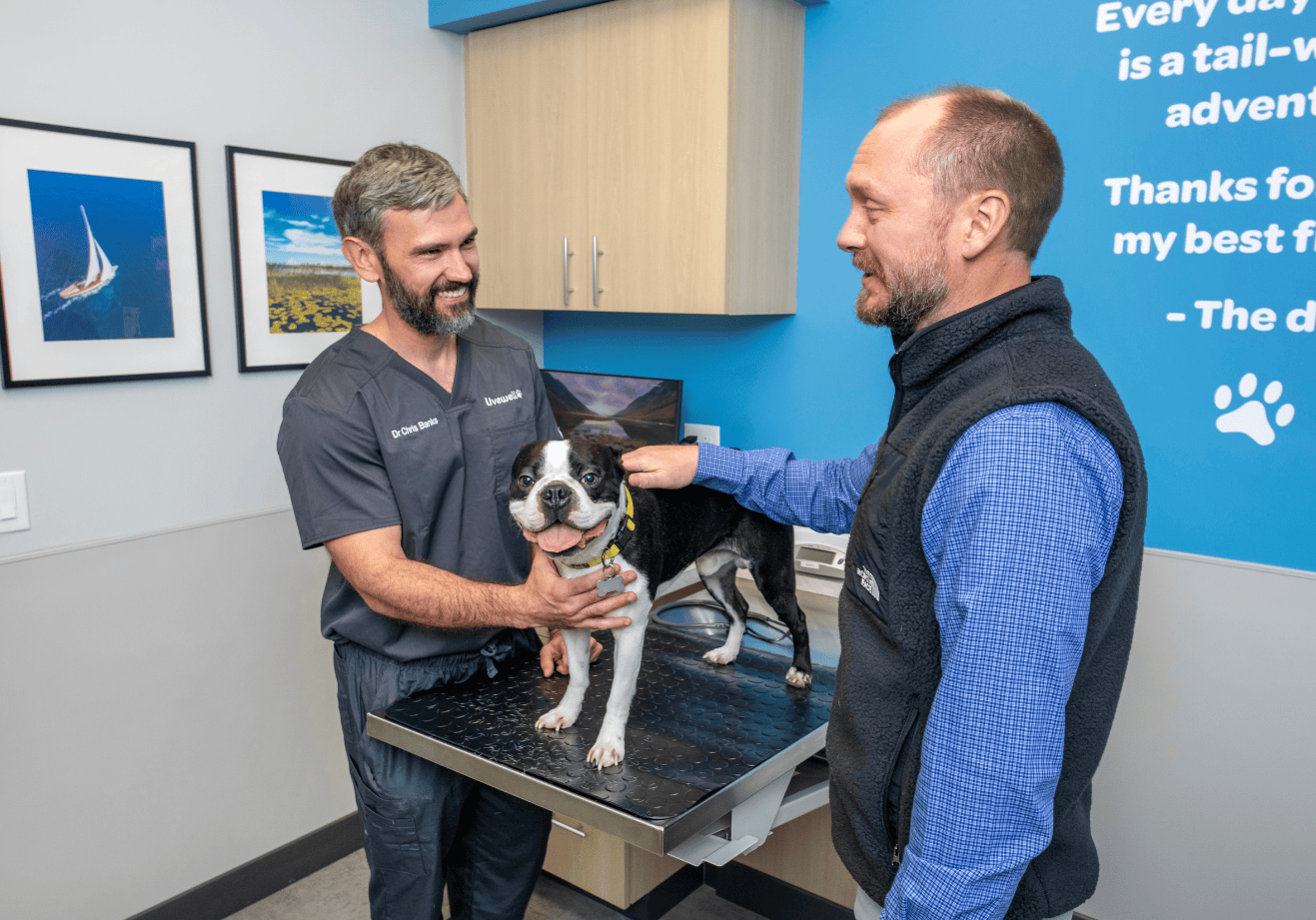 Dr. Chris Banks visiting with pet and pet owner in office